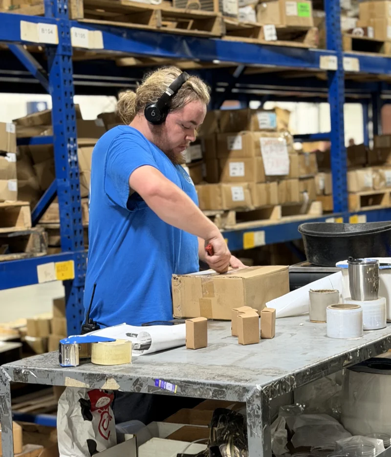 Eagle Sales warehouse opening boxes of new hardware stock.